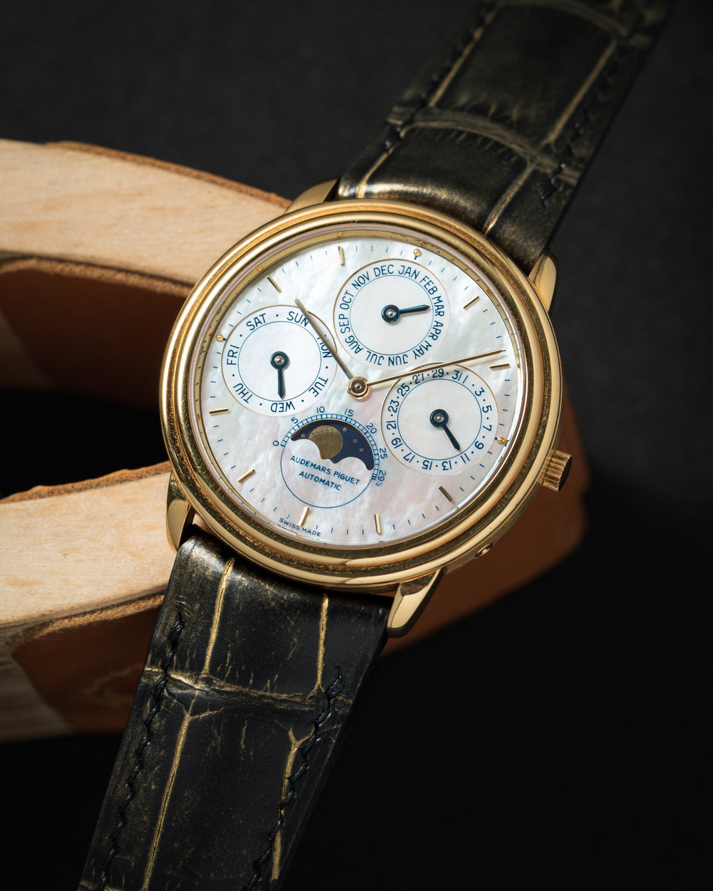 A watch paired with a custom Delugs strap